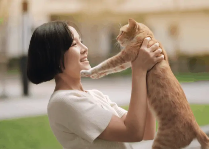 Korean woman lifting her cat 