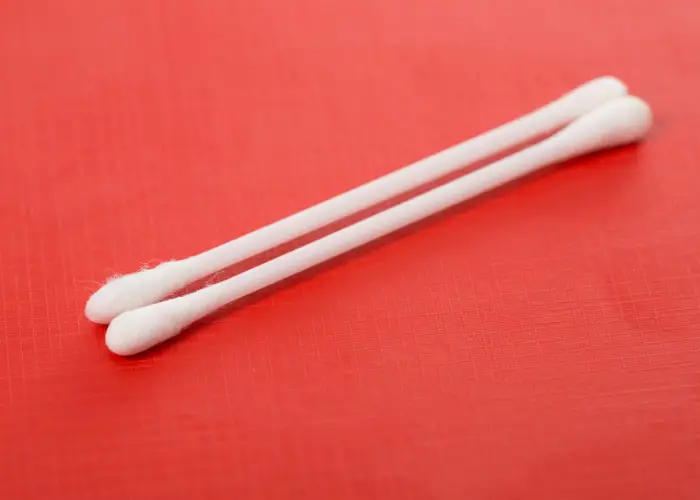2 cotton buds on red background